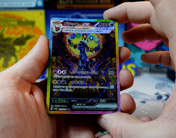 Hands holding a Japanese Umbreon ex special art rare
